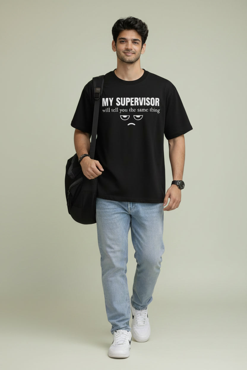Person wearing a black Oversized t-shirt with text for corporate office employees