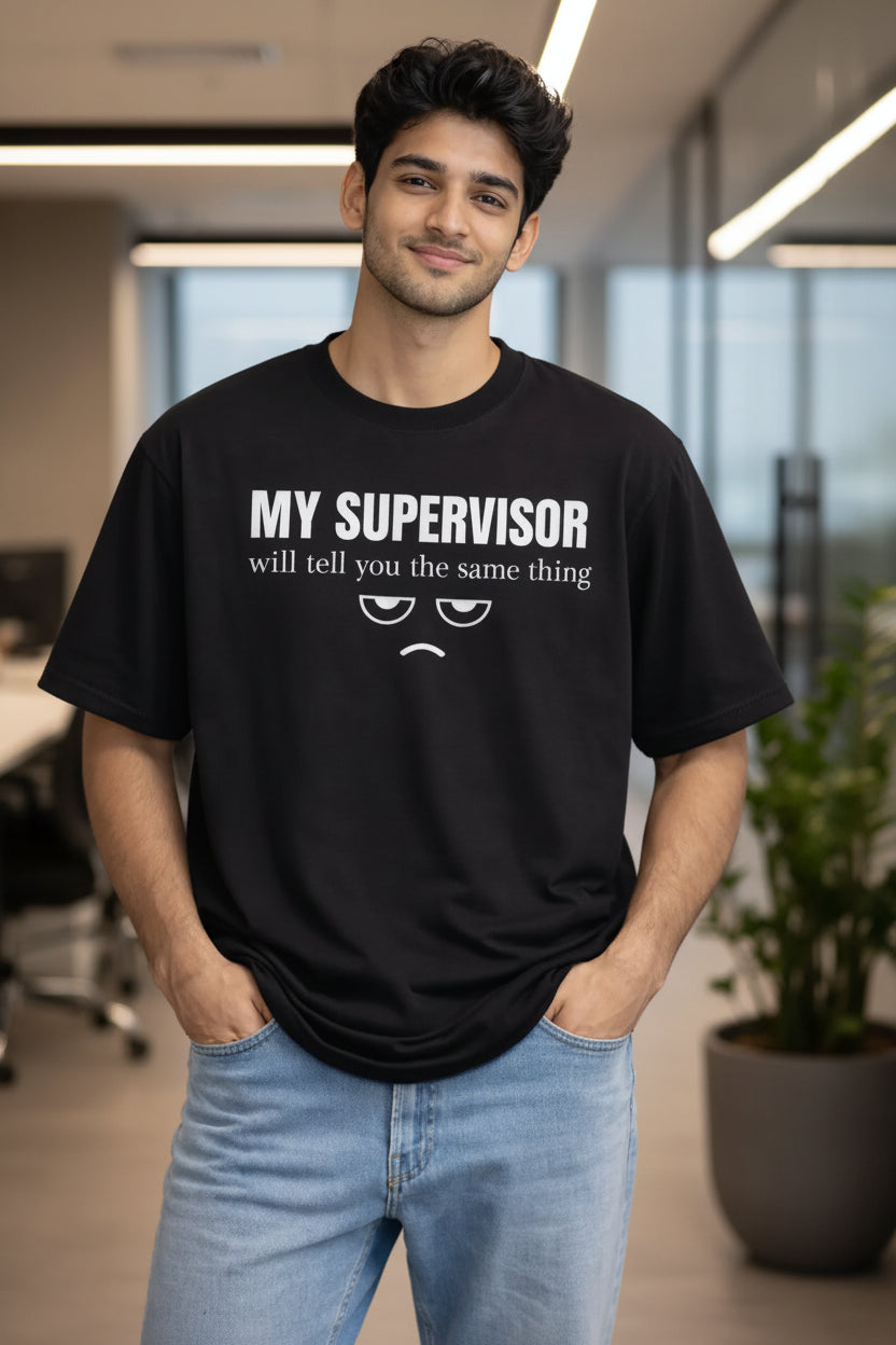 Person wearing a black t-shirt with humorous text in a corporate office