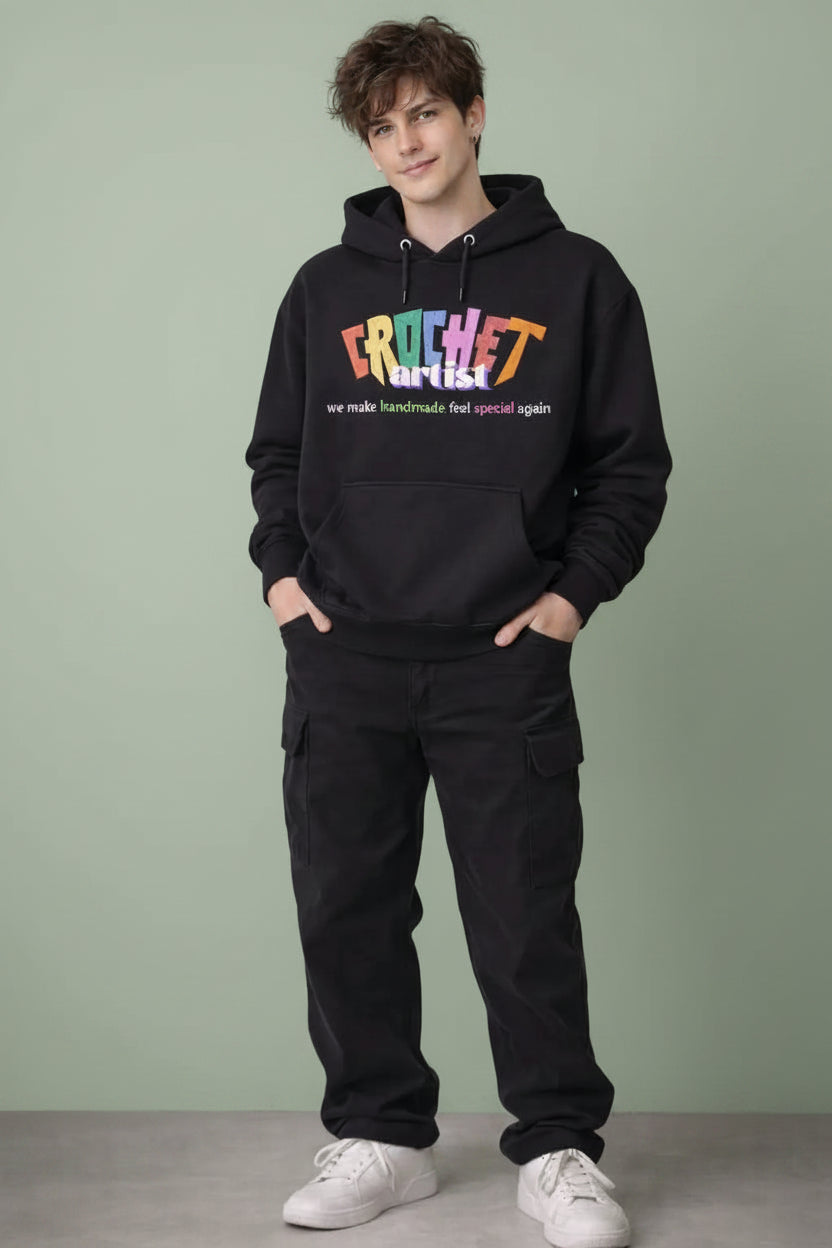 Person wearing a black hoodie with colorful text 