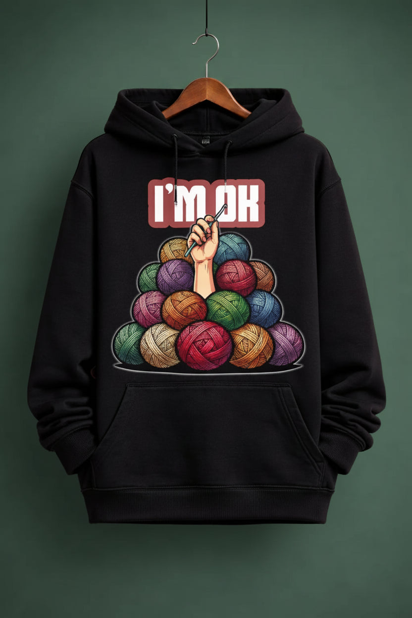 Black oversized hoodie with colorful yarn design on a hanger