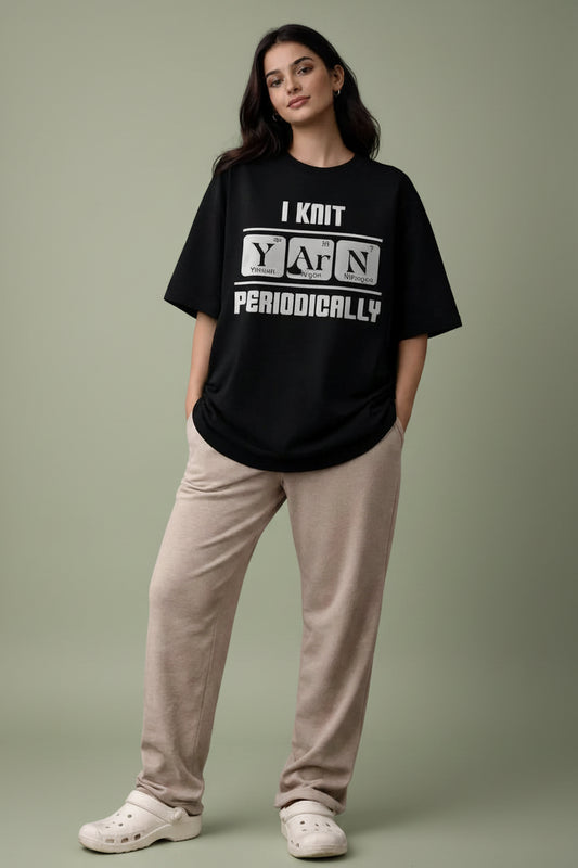 Person wearing a black oversized t-shirt with text and casual fashion