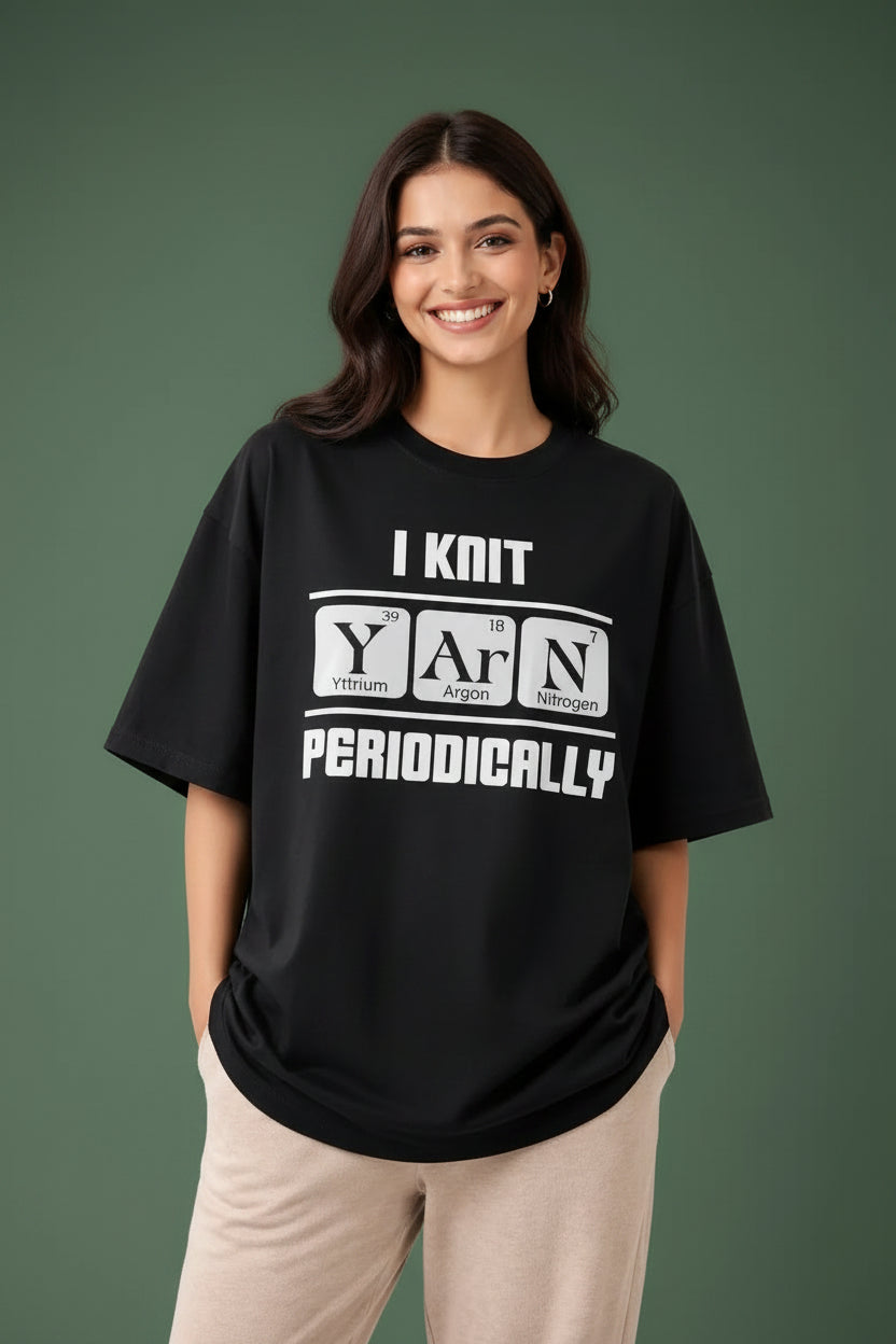 Woman wearing a black oversized t-shirt with 'i knit  yarn periodically' print for casual fashion